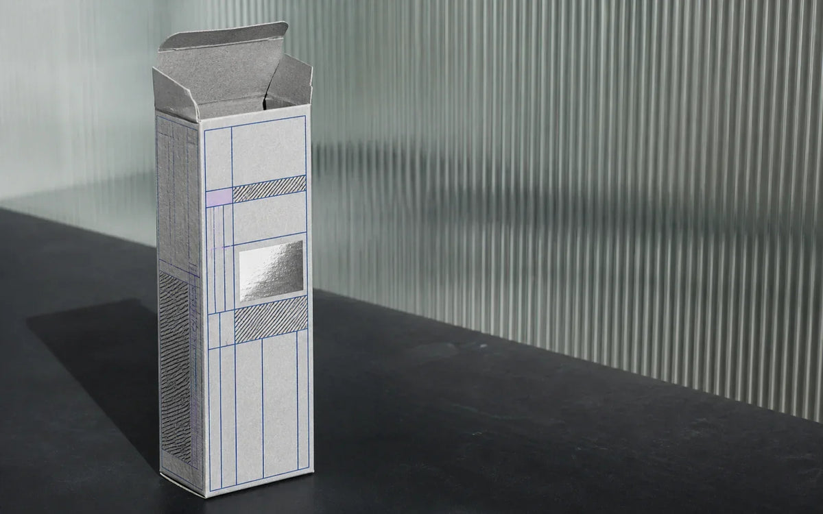 Gray carton with blue grid graphics and a silver panel in a materials lab