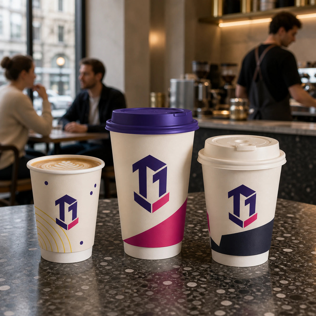 Illustrative mockup of three custom double wall coffee cup sizes in a café