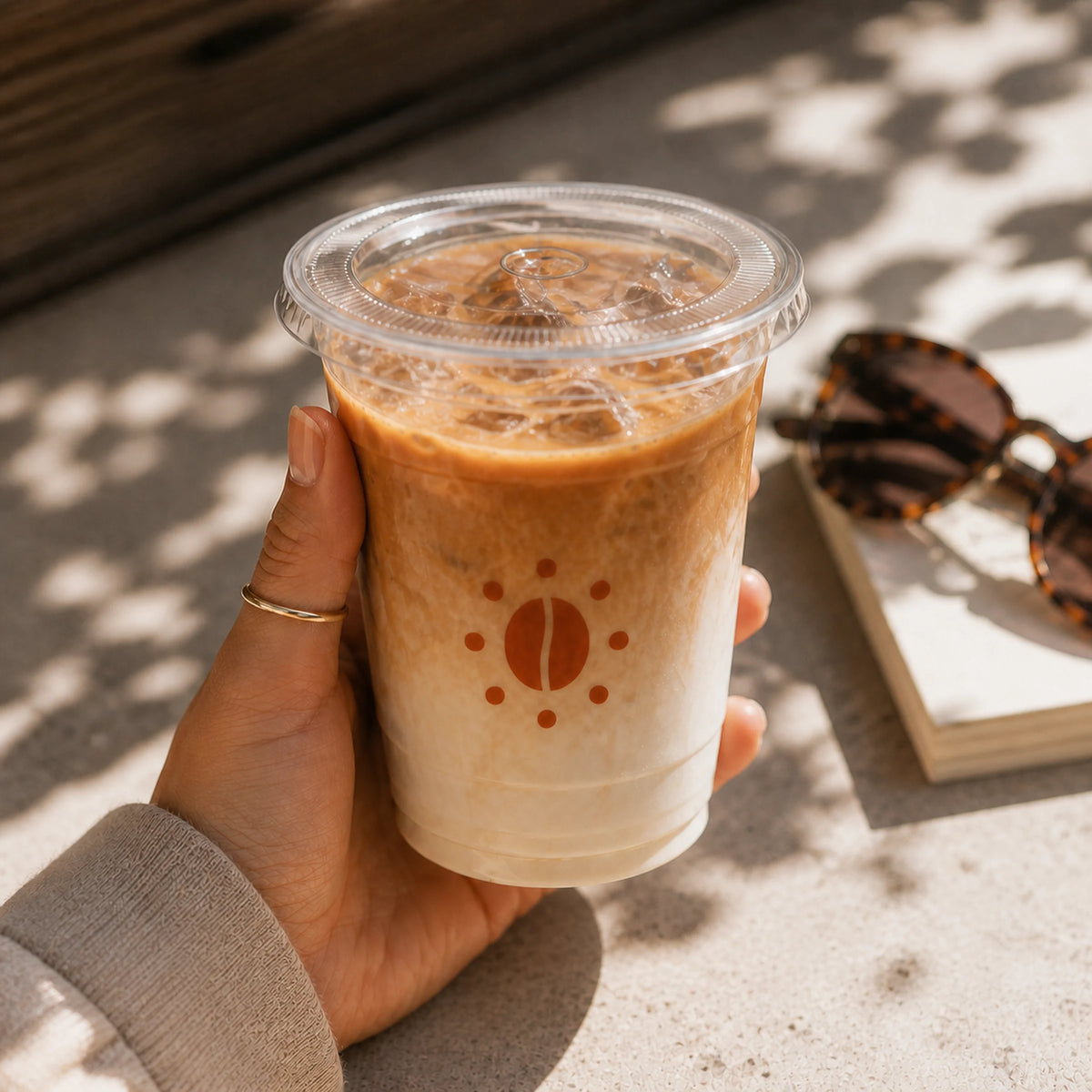 AI-generated mockup of a custom clear PET cup with iced latte and flat lid