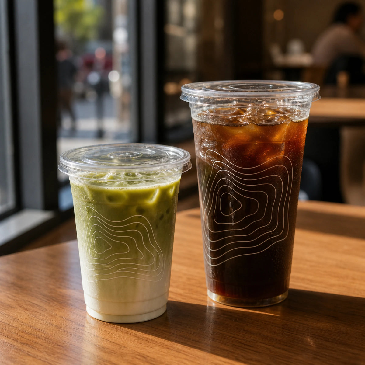 AI-generated mockup of two printed clear PET cups with iced cafe drinks