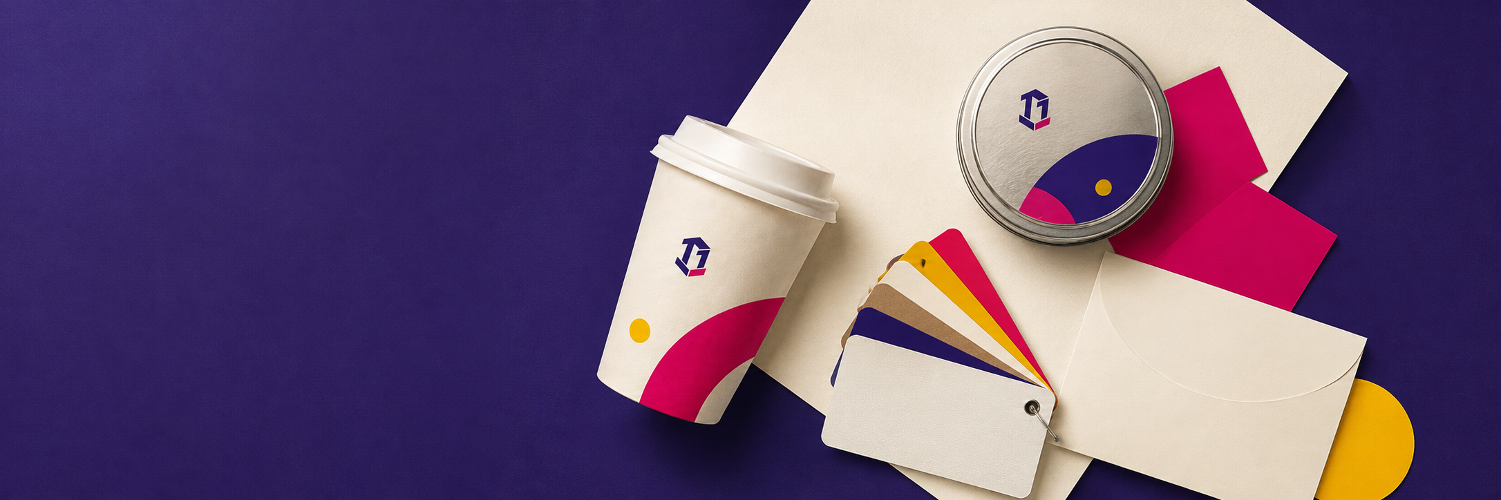 Overhead packaging planning scene with a paper cup, metal tin, material swatches and welcome card